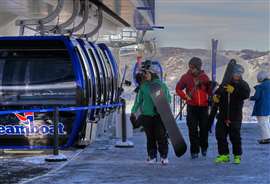 Skiers at Steamboat resort get ready to board Big Blue