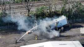 Firefighters cut a hole in a burning truck in Columbus, Ohio on April 18, 2024. The Columbus Dispatch reported that the truck contained lithium-ion batteries.