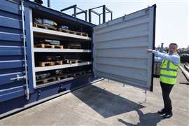 Marc Trent, CEO of Poole, England-based vehicle recycler Charles Trent Ltd, opens up a specially-built, fire-safe container for batteries salvaged from recycled electric vehicles and hybrids on June 7, 2023.