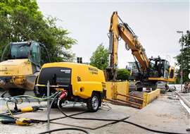 A Kaeser M50E SFC compressor shown working alongside construction equipment on a site in Germany. (Photo: Kaeser)