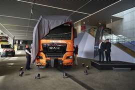 Orange MAN TGX tractor unit being unveiled at the launch