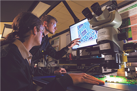 Technicians analyze circuitry at John Deere's Product Verification Lab