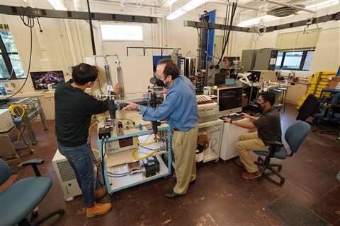 Researchers working on the new charging station cable