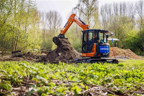 Excavator operating in woodland